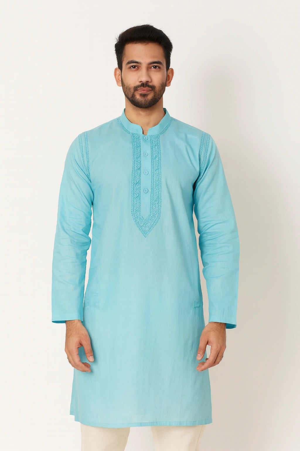 Man wearing a lucknowi chikankari light blue kurta against a white background