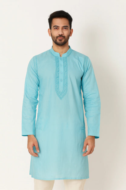 Man wearing a lucknowi chikankari light blue kurta against a white background