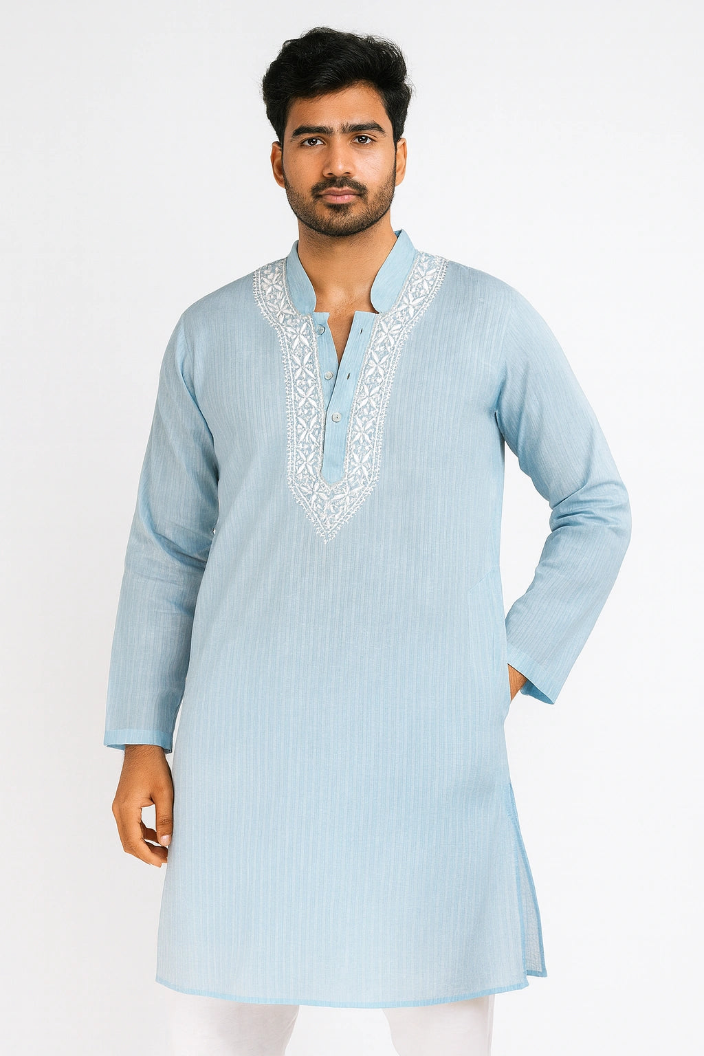 Man wearing a light blue kurta with white embroidery on a white background