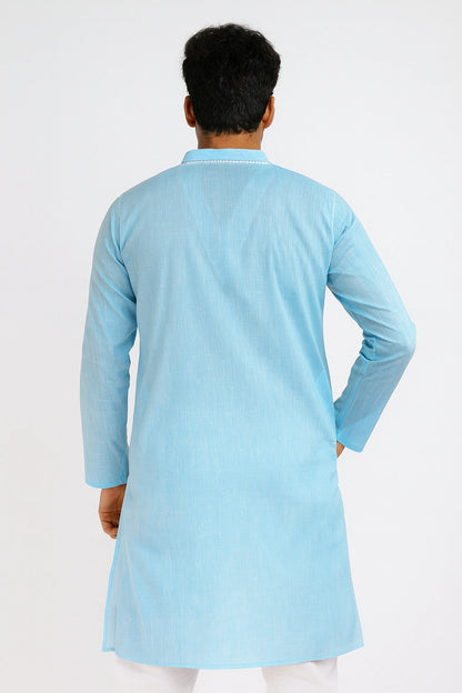 Person wearing a lucknowi chikankari light blue kurta against a white background