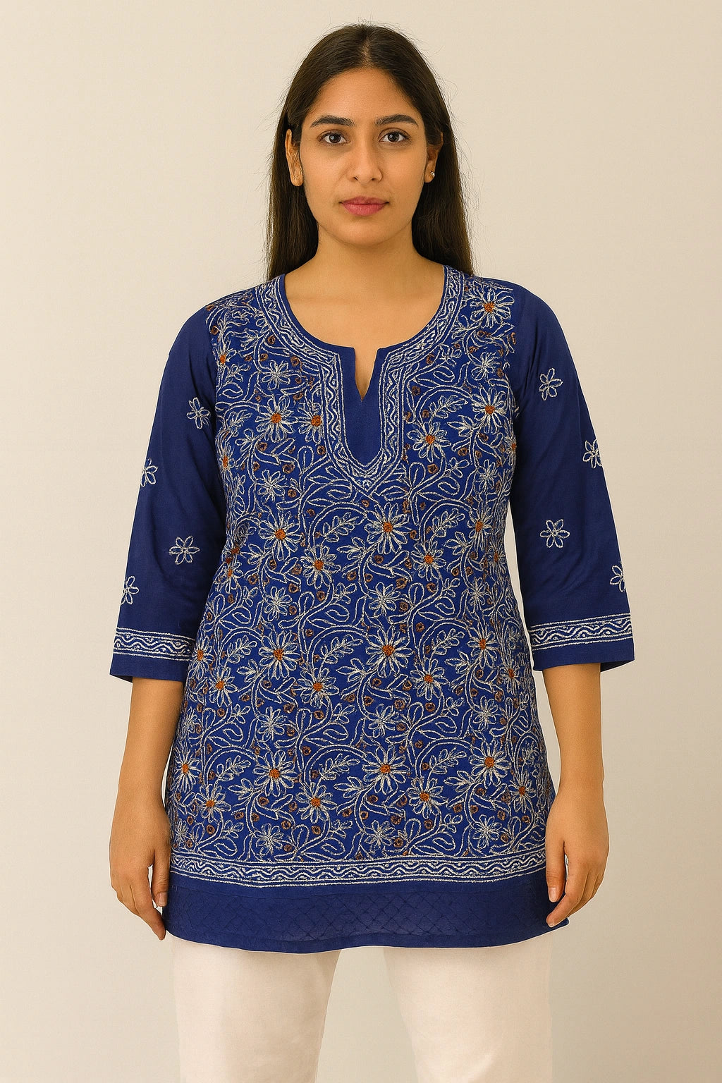 Woman wearing a lucknowi chikankari  blue patterned kurta against a beige background
