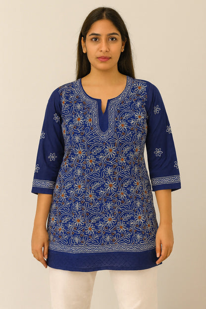 Woman wearing a lucknowi chikankari  blue patterned kurta against a beige background