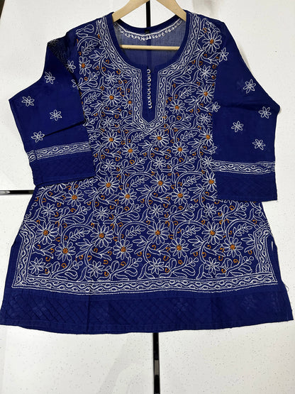 Blue embroidered traditional outfit on a hanger against a white background