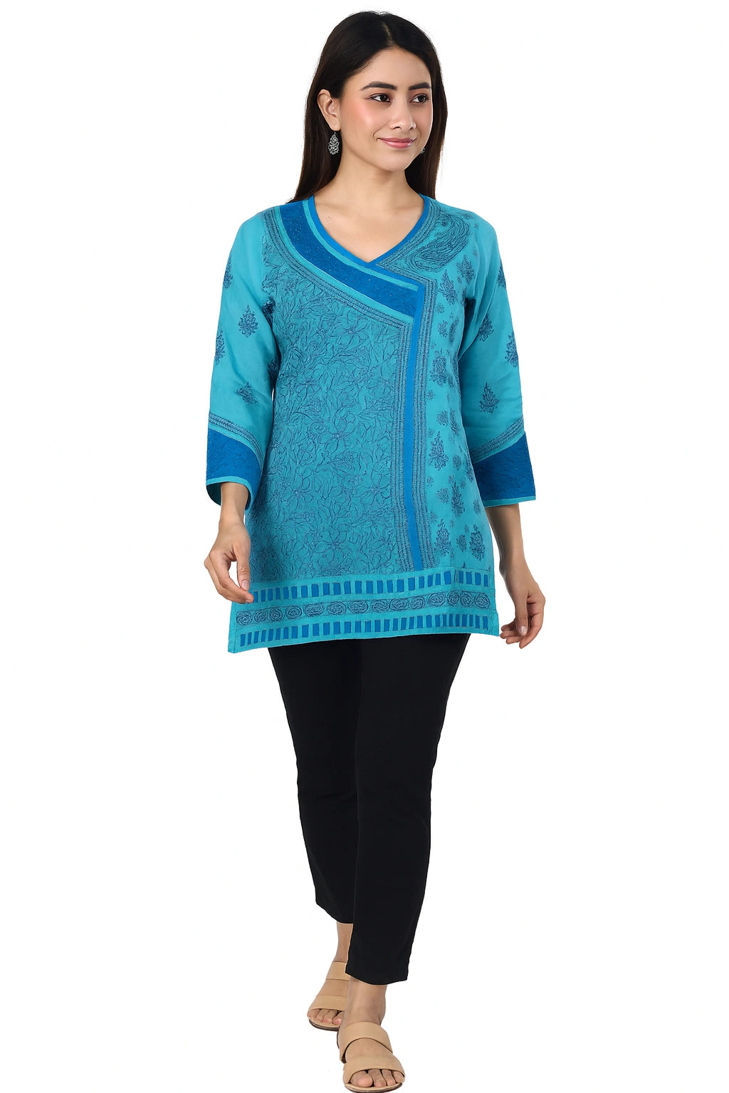 Woman wearing a lucknowi chikankari blue patterned kurta with black pants on a white background