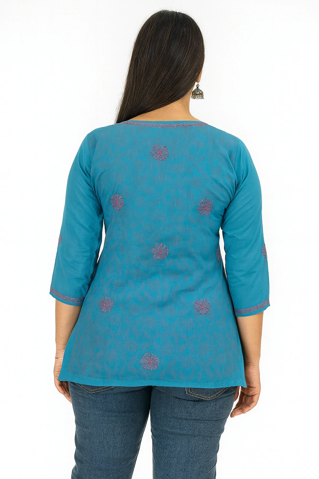 Woman wearing a lucknowi chikankari  blue top with floral patterns on a white background