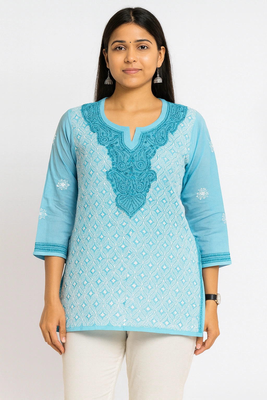 Woman wearing a lucknowi chikankari blue patterned kurta with white pants on a white background