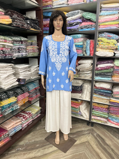 Mannequin wearing a lucknowi chikankari blue top in a fabric store.
