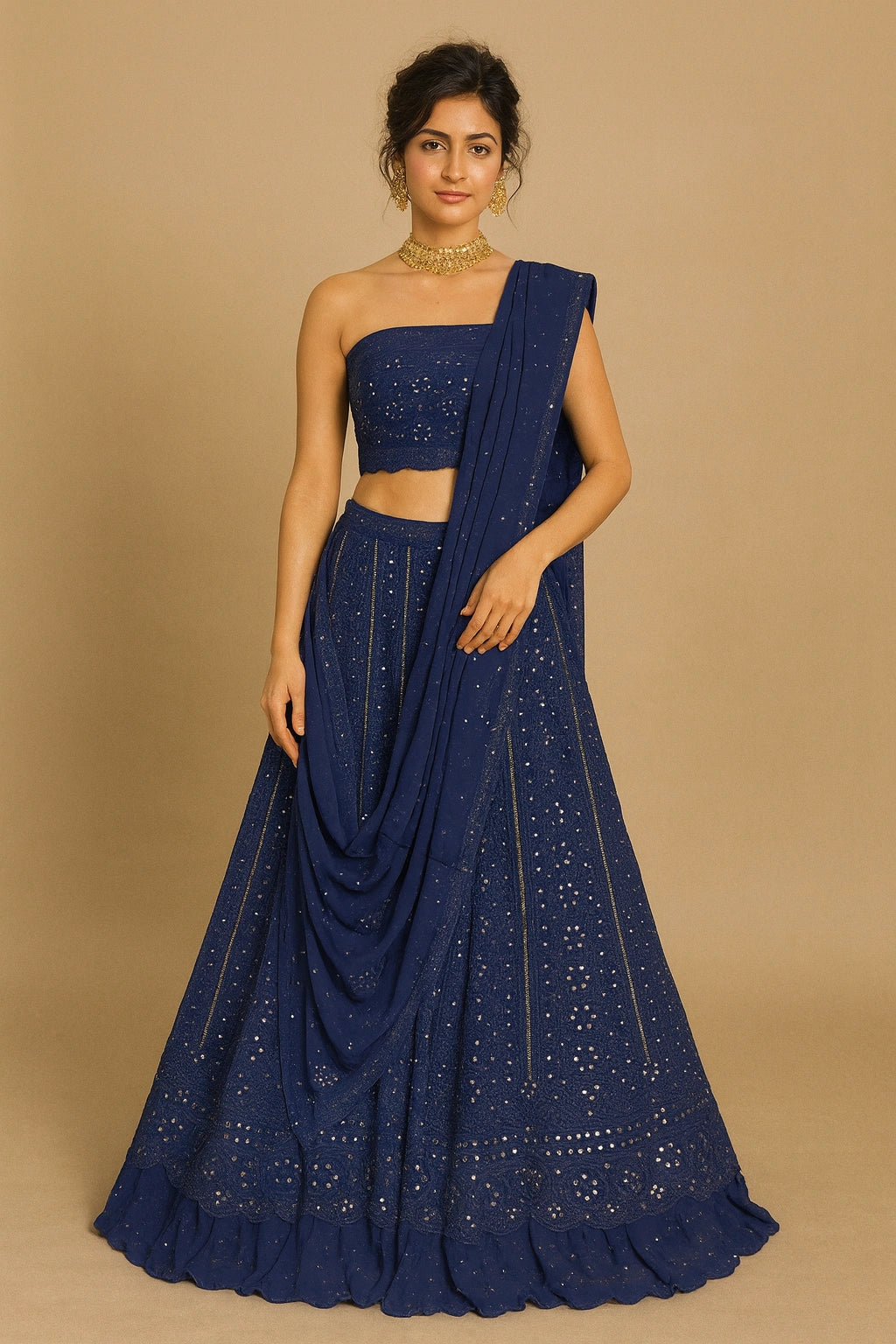Woman wearing a blue saree with a matching blouse on a beige background