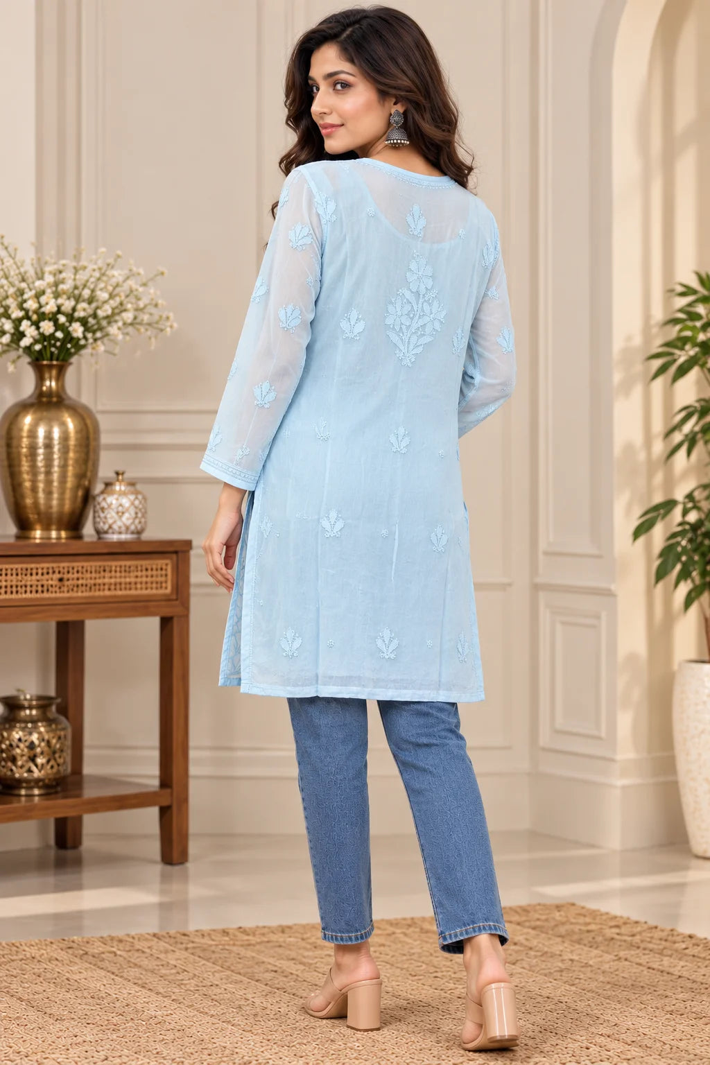 Woman wearing a lucknowi chikankari blue-colored kurta with white floral patterns