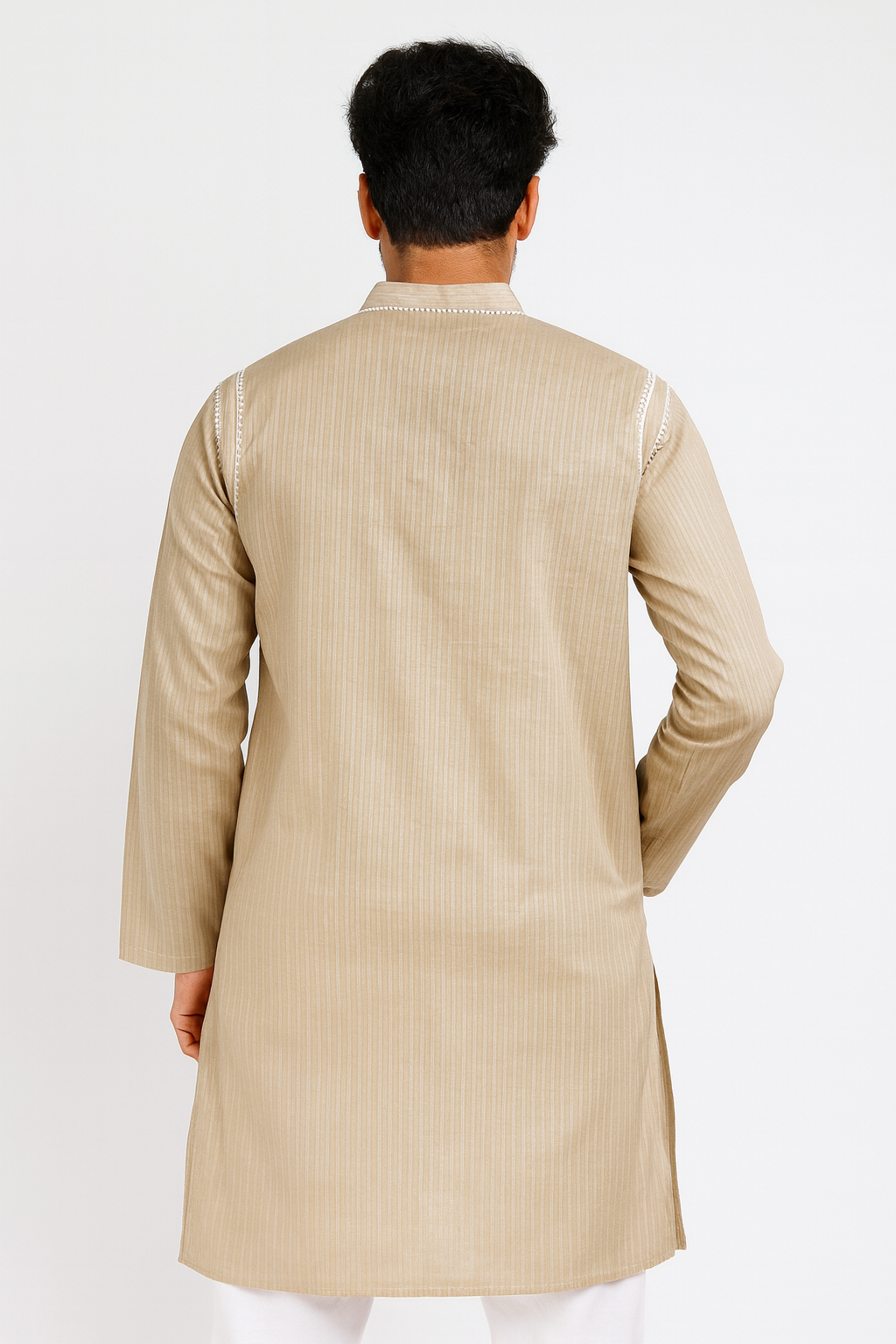 Man wearing a lucknowi chikankari beige kurta against a white background