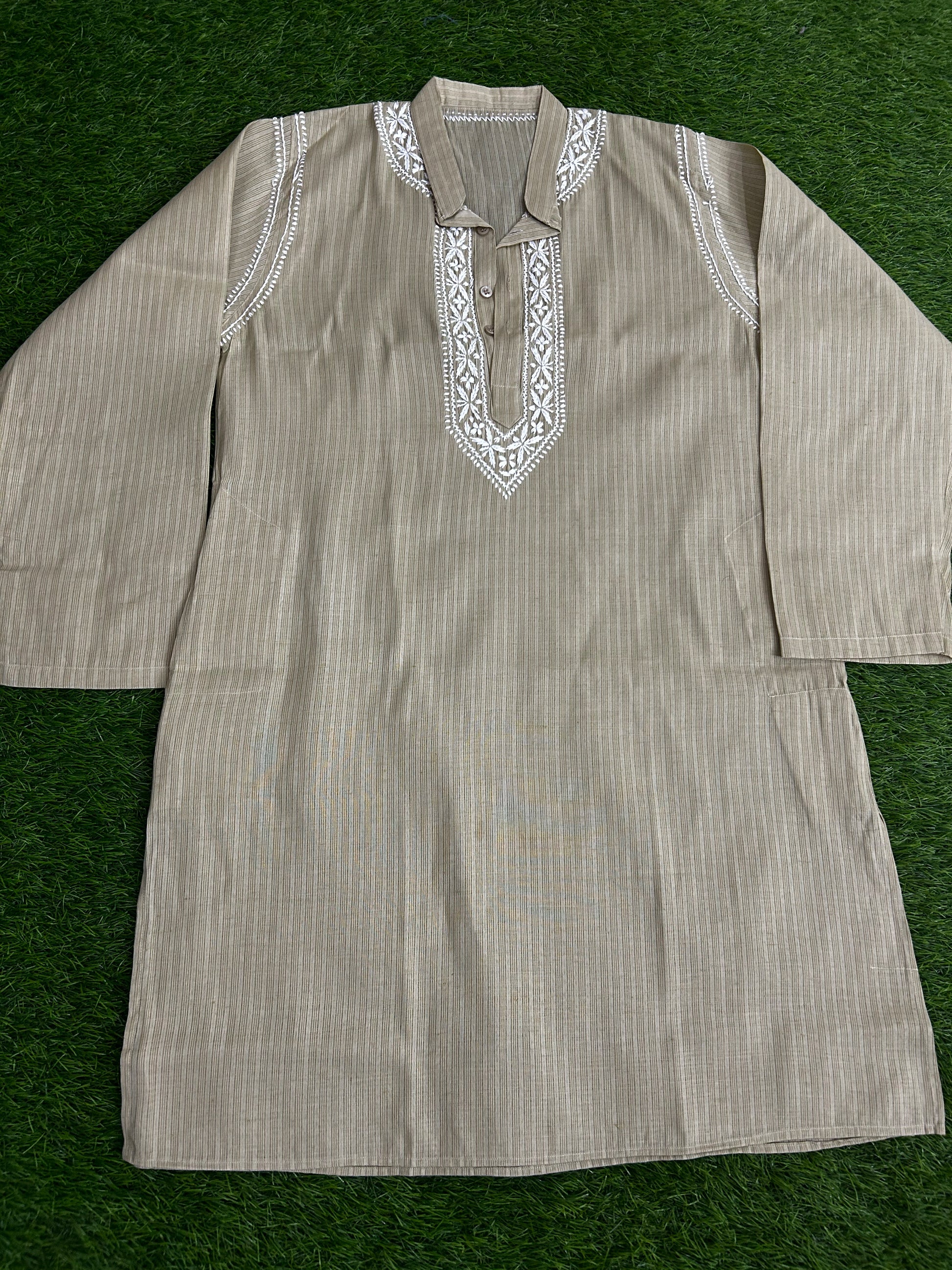 Striped kurta with embroidered details on a green background