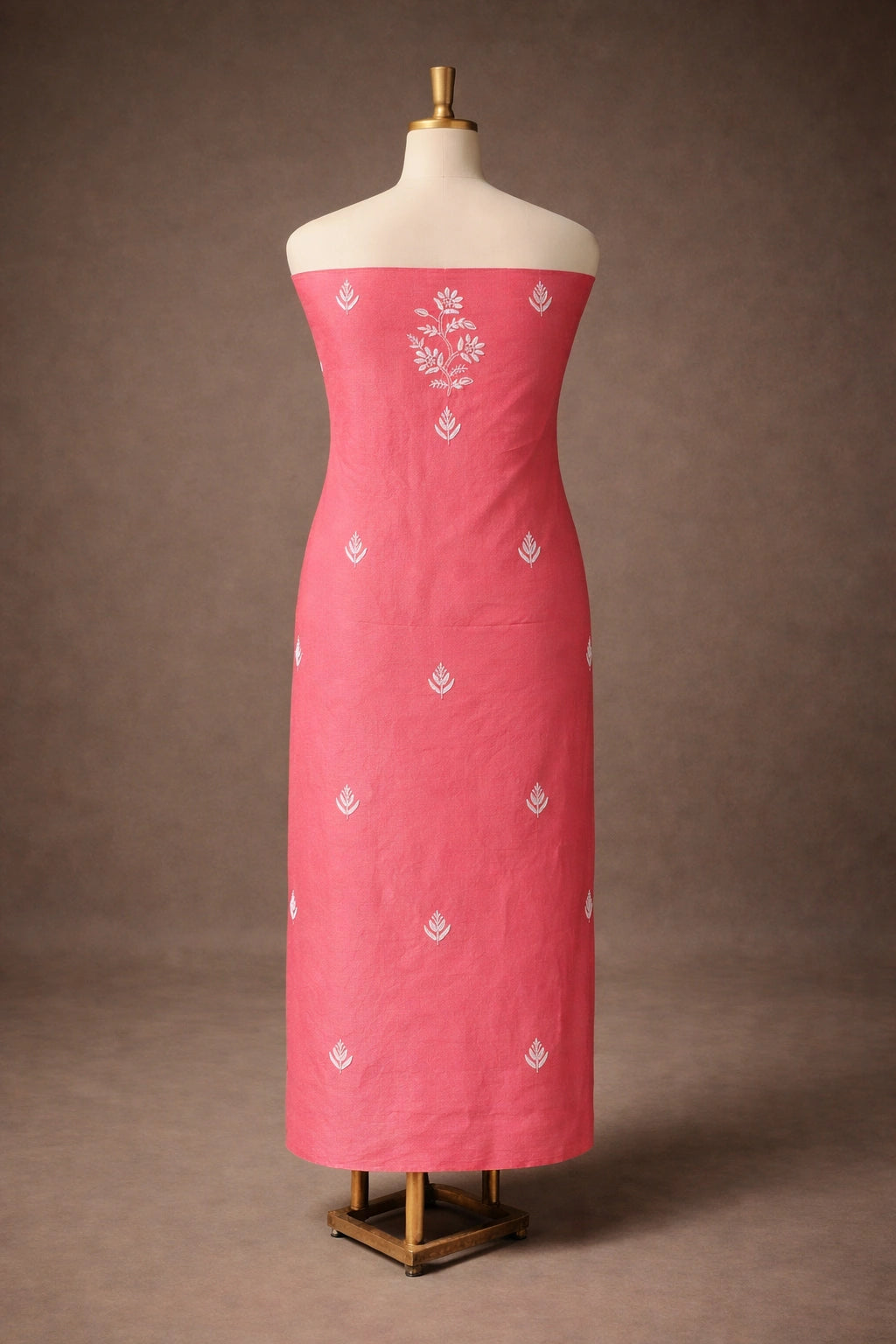 Red dress with white floral patterns on a mannequin against a brown background