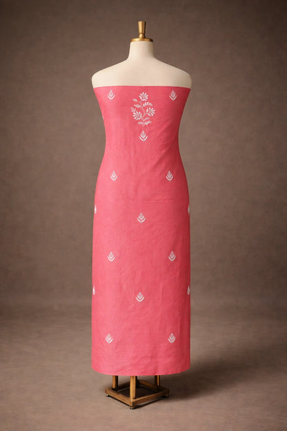 Red dress with white floral patterns on a mannequin against a brown background