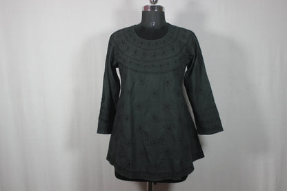 lucknowi chikankari Dark green dress on a mannequin against a plain background
