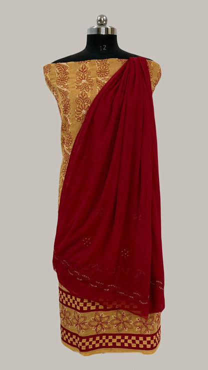 Lucknowi chikankari Red saree with gold border on a mannequin against a gray background