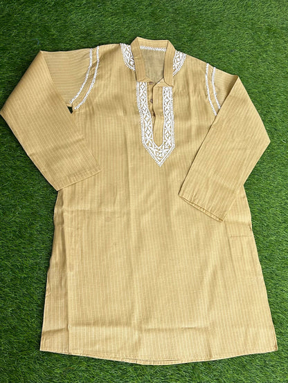 Beige kurta with white embroidery on a green background