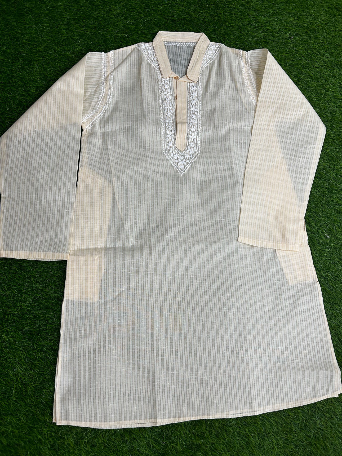 White embroidered kurta on a green background