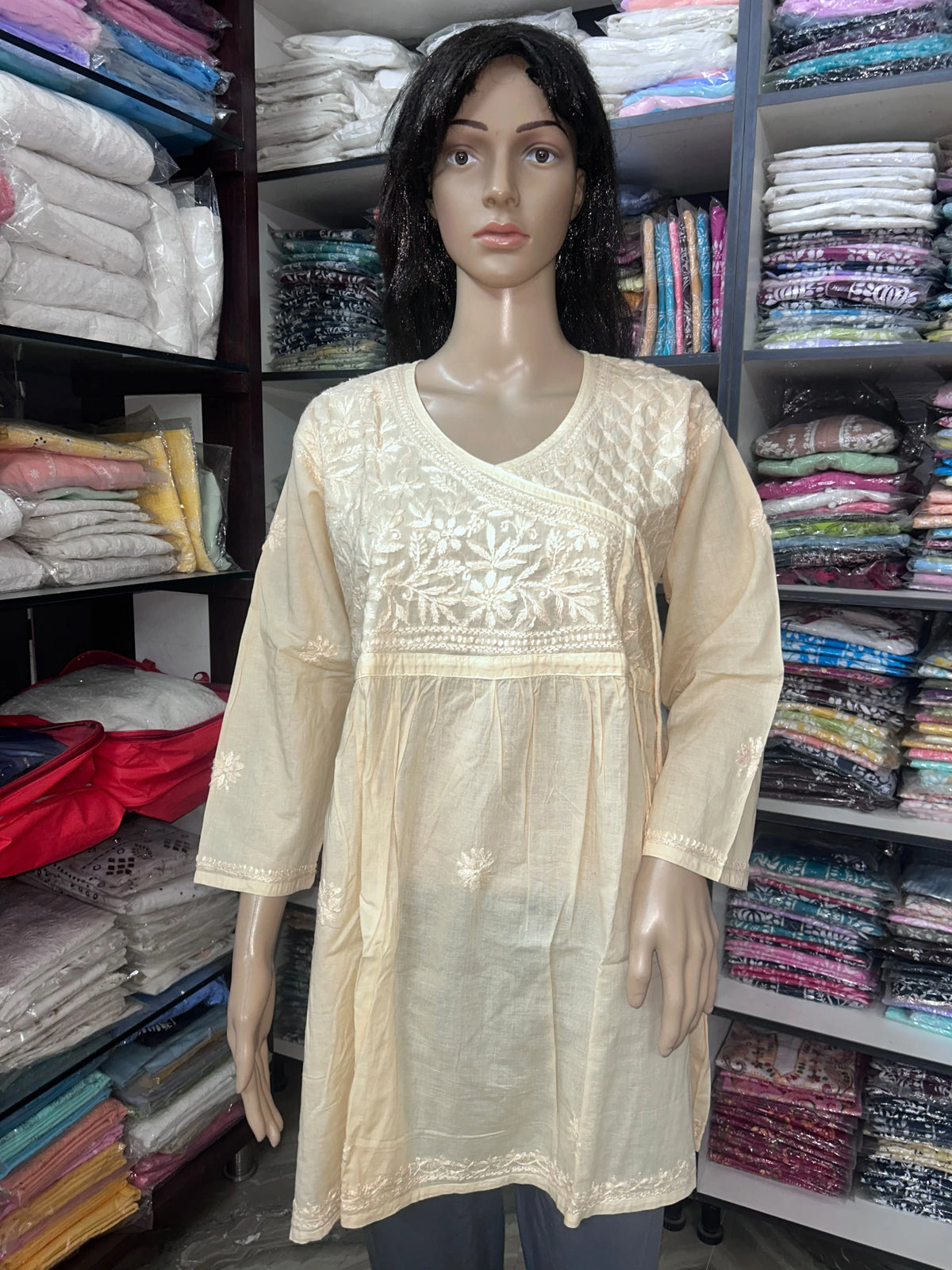 lucknowi chikankari Mannequin wearing a top in a fabric store.