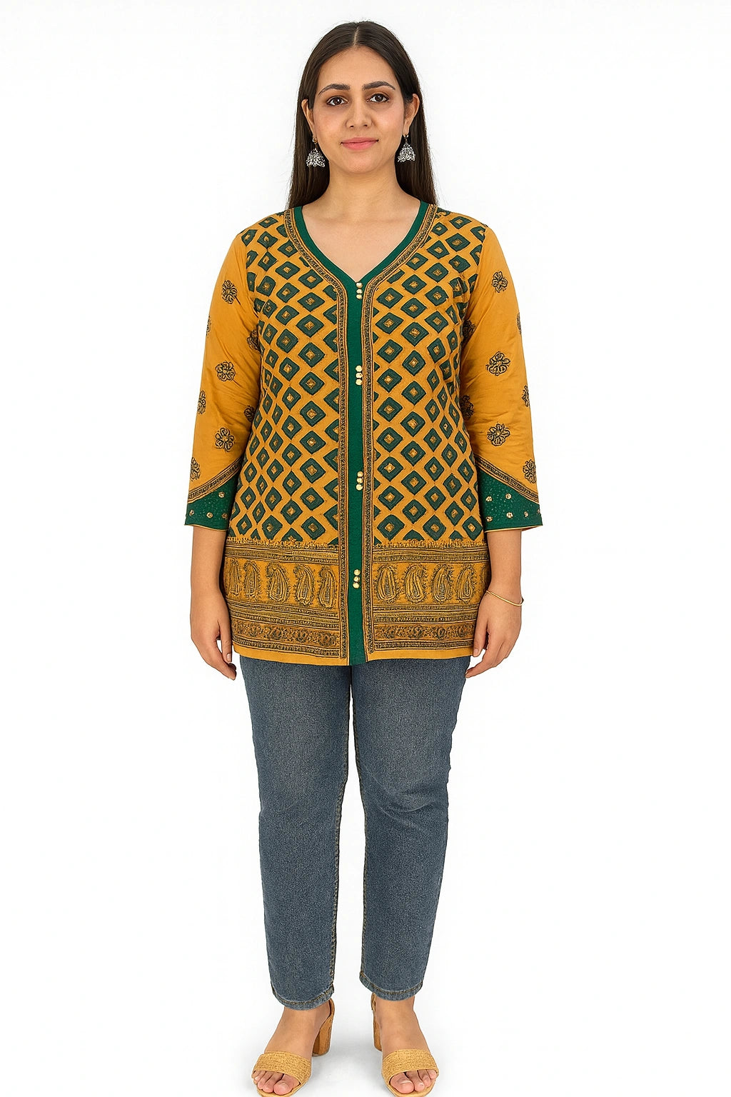 Woman wearing a lucknowi chikankari mustard yellow and green patterned top with blue jeans on a white background