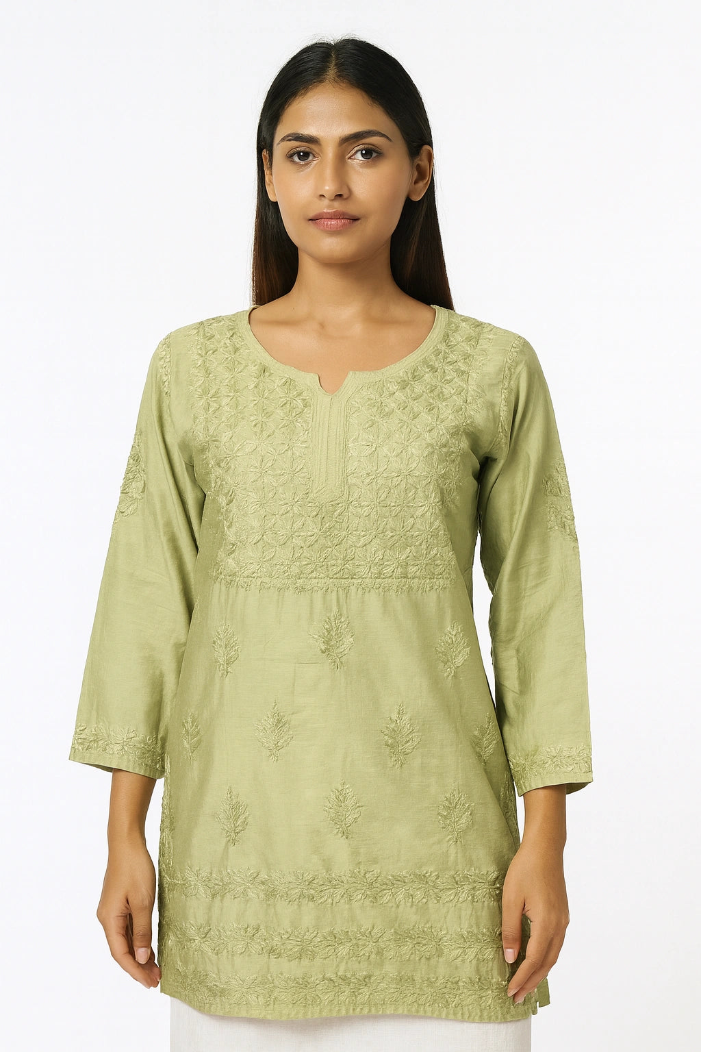 Woman wearing a light green embroidered kurta against a white background