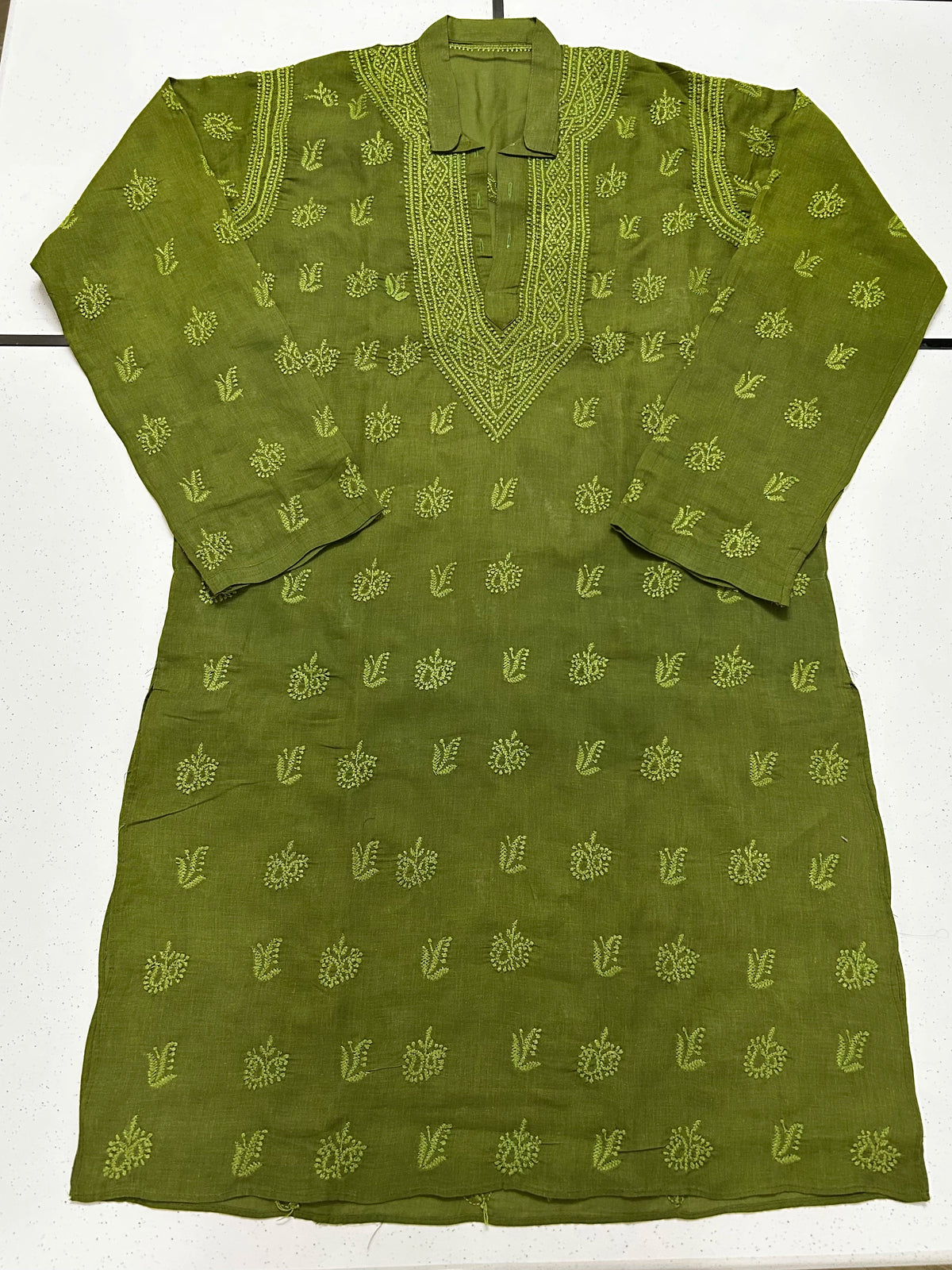 An olive green long-sleeve kurta with light green embroidered motifs and a matching embroidered V-neckline, laid flat on a white surface.