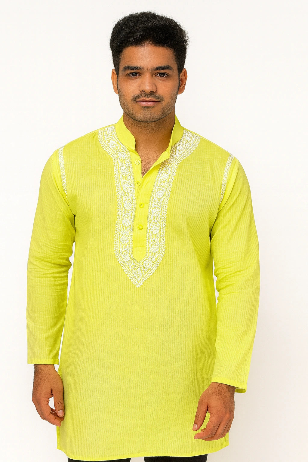Man wearing a bright yellow kurta with white embroidery on a white background