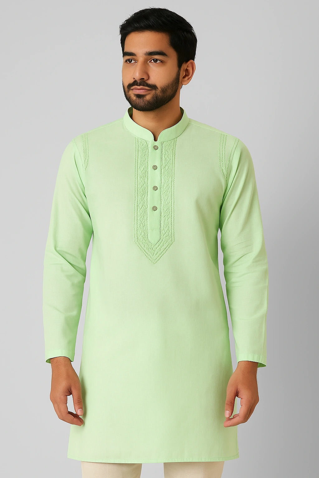Man wearing a lucknowi chikankari light green kurta with white pants on a gray background