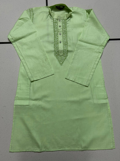 Green kurta with intricate embroidery on a gray background