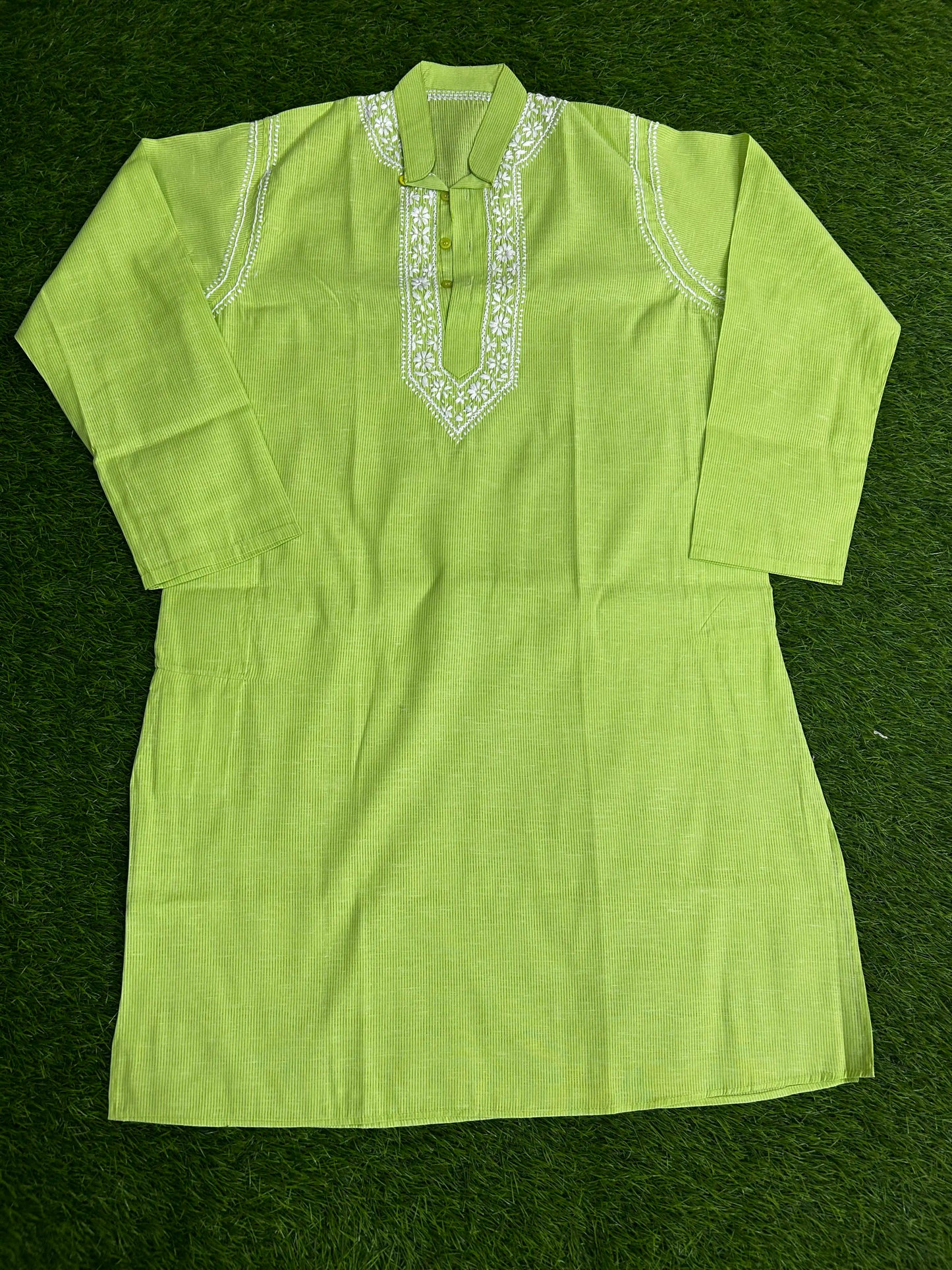 Green kurta with white embroidery on a green background