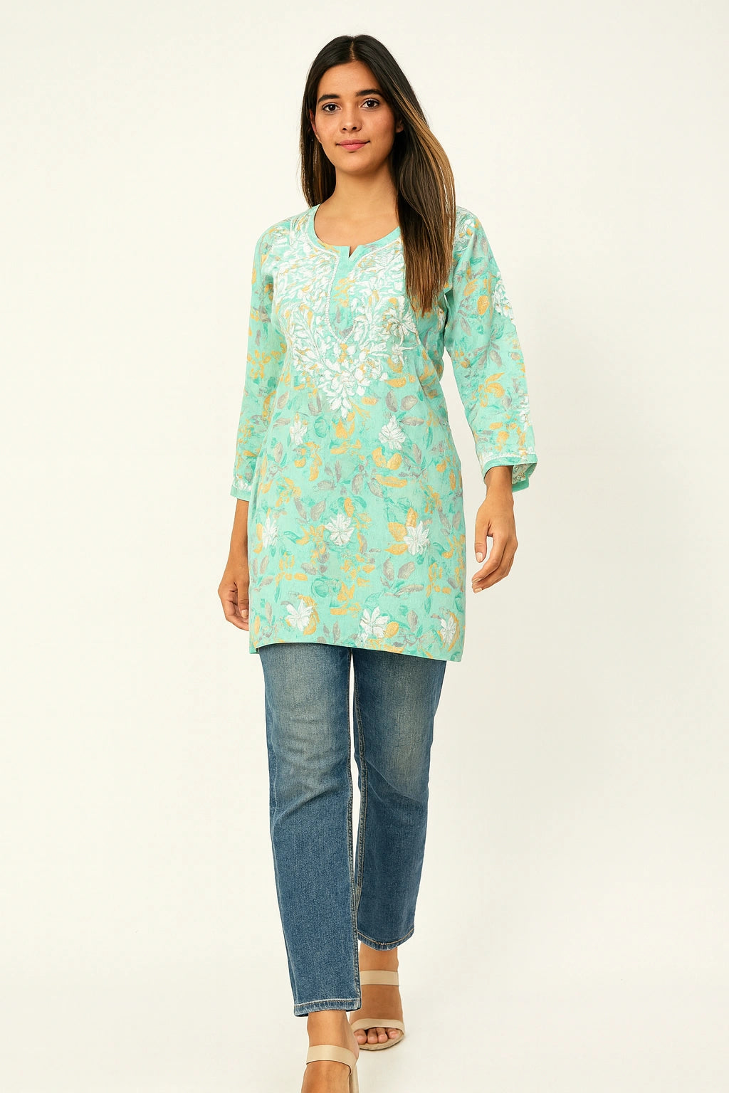 lucknowi chikankari Woman wearing a light blue floral tunic and jeans on a white background
