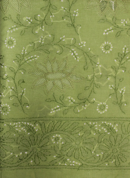 Close-up of green fabric with intricate floral embroidery