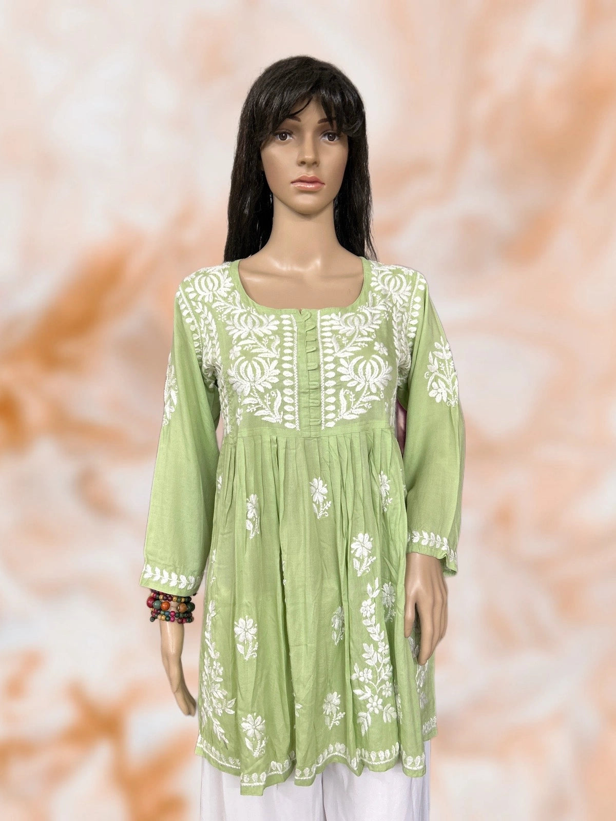 Mannequin wearing a lucknowi chikankari green dress.