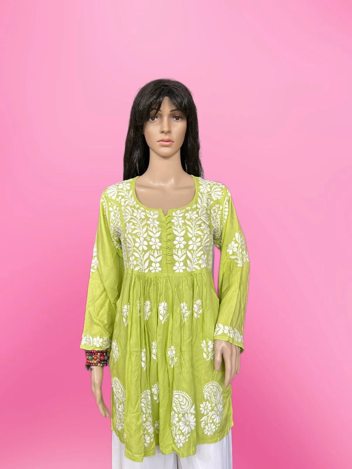 Mannequin wearing a lucknowi chikankari green dress.