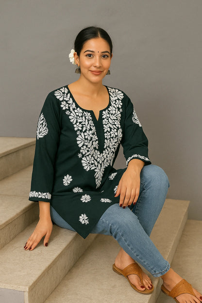 Woman wearing a light blue embroidered kurta on a beige background