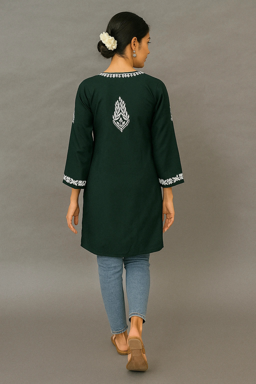 Person wearing a lucknowi chikankari light green top with a subtle pattern on a beige background