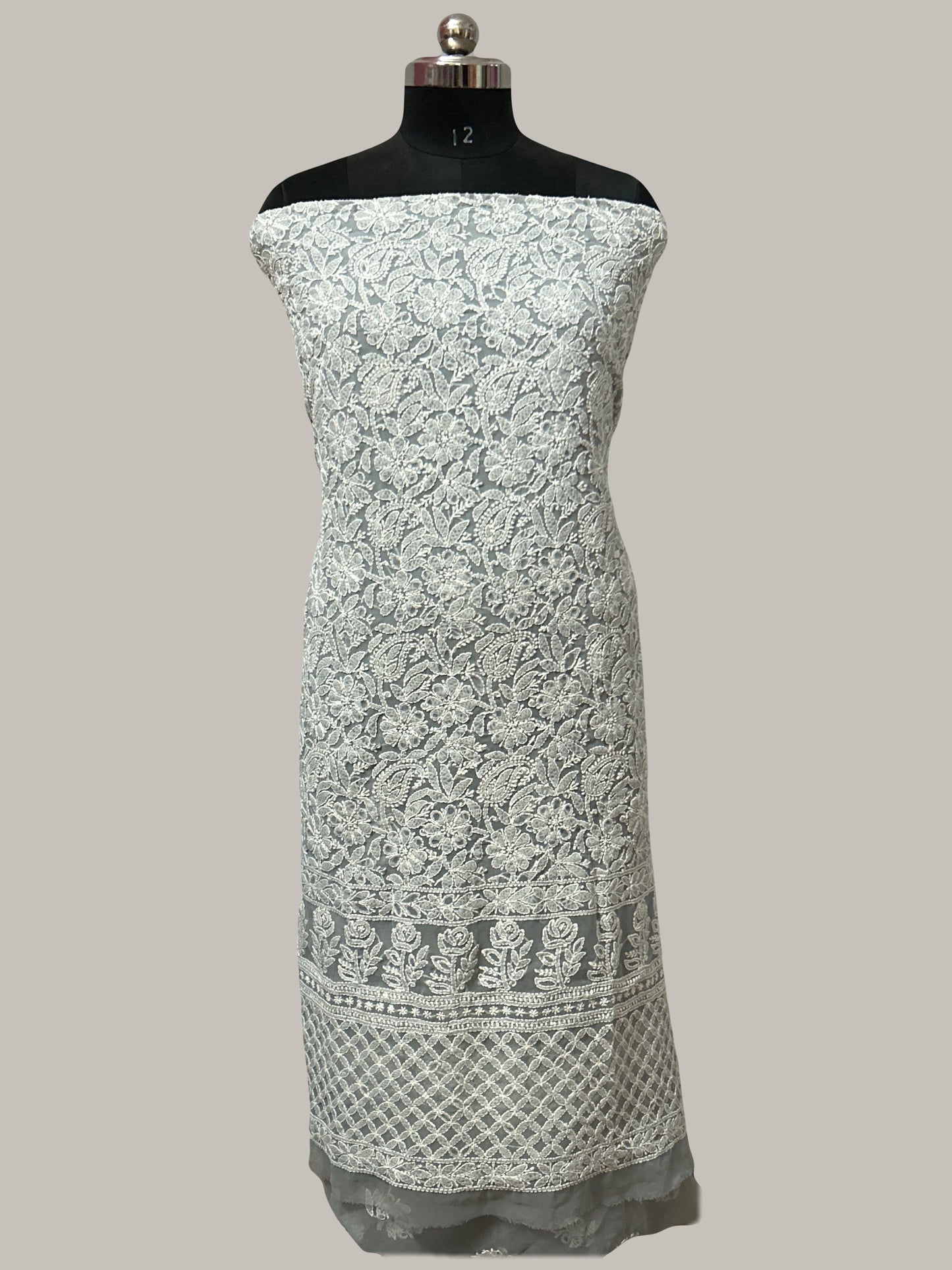 Lucknowi Chikankari White floral patterned dress on a mannequin against a gray background