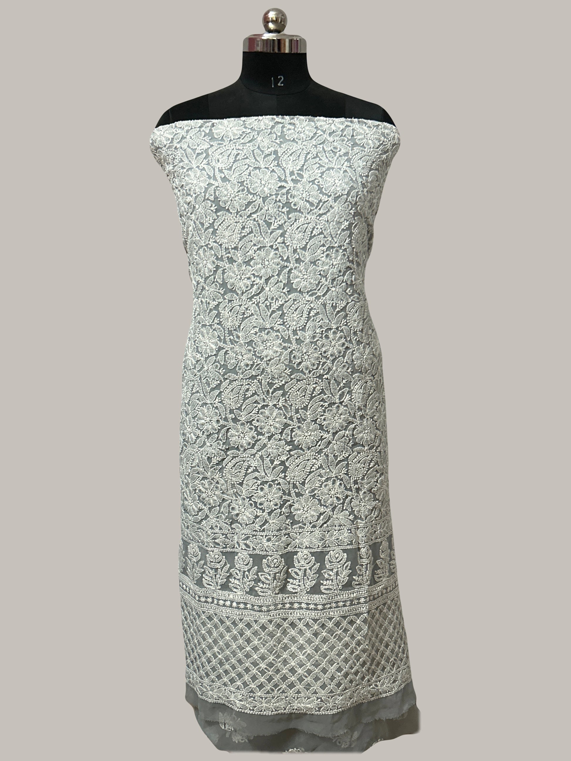Lucknowi Chikankari White floral patterned dress on a mannequin against a gray background