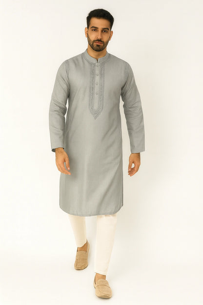 Man wearing a lucknowi chikankari  gray kurta with white pants on a white background