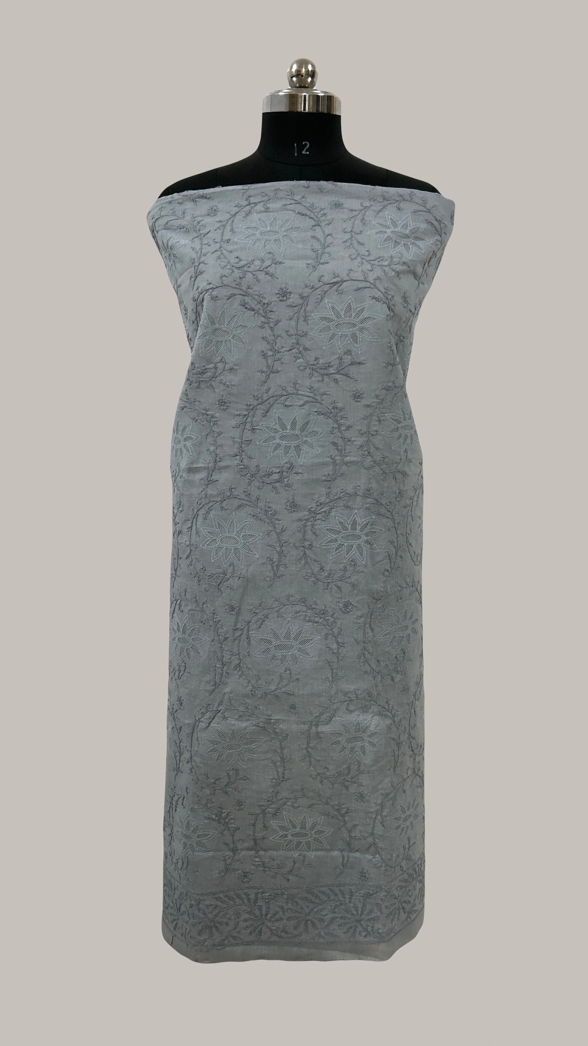 Gray strapless dress on a mannequin against a plain background