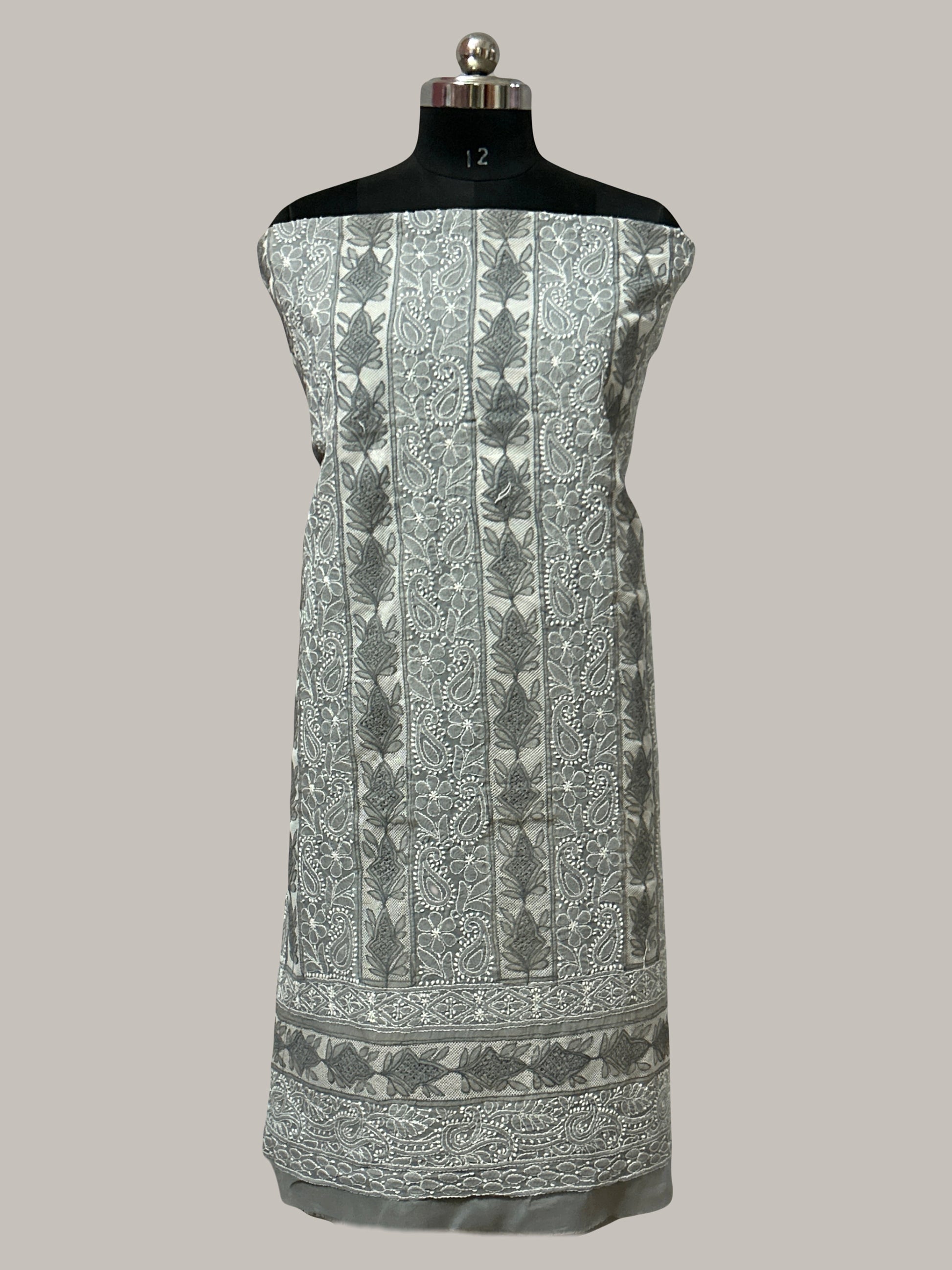 lucknowi chikankari Fabric with intricate patterns on a mannequin against a plain background