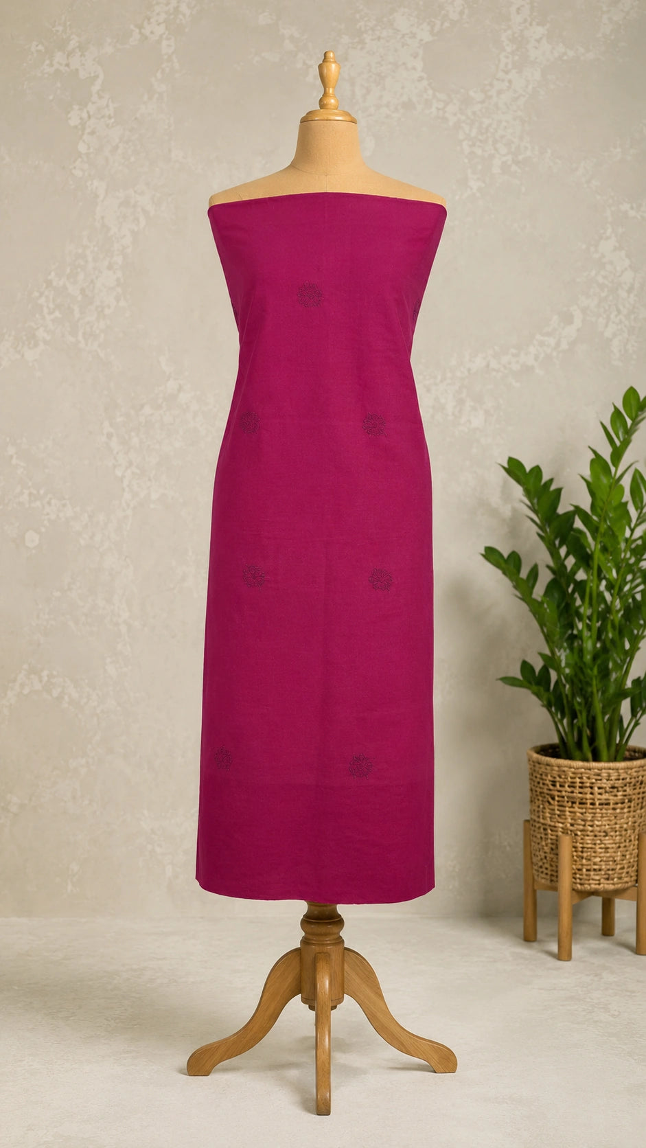 Lucknowi chikankari Fuchsia strapless dress on a wooden mannequin against a neutral background