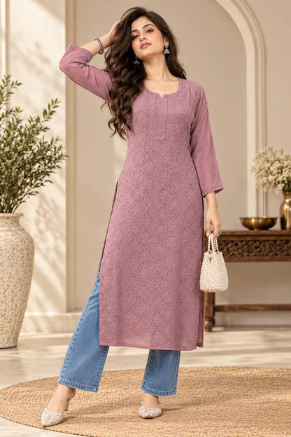 Woman wearing a lucknowi chikankari Mauve pink-colored kurta with white floral patterns 