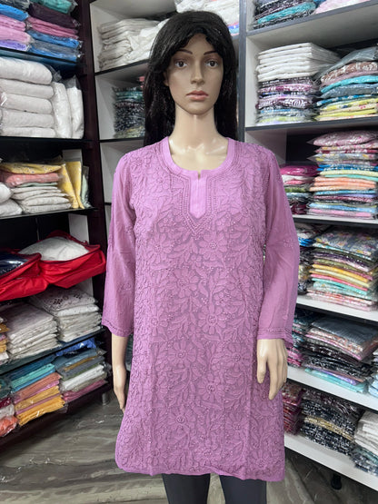 Woman wearing a lucknowi chikankari mauve-colored kurta with white patterns on a white background