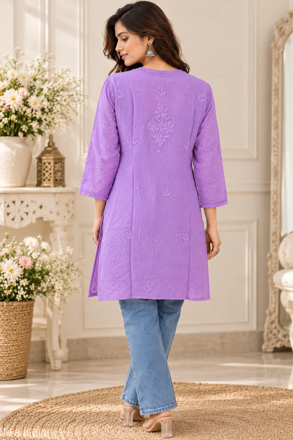 Woman wearing a lucknowi chikankari purple-colored kurta with white floral patterns