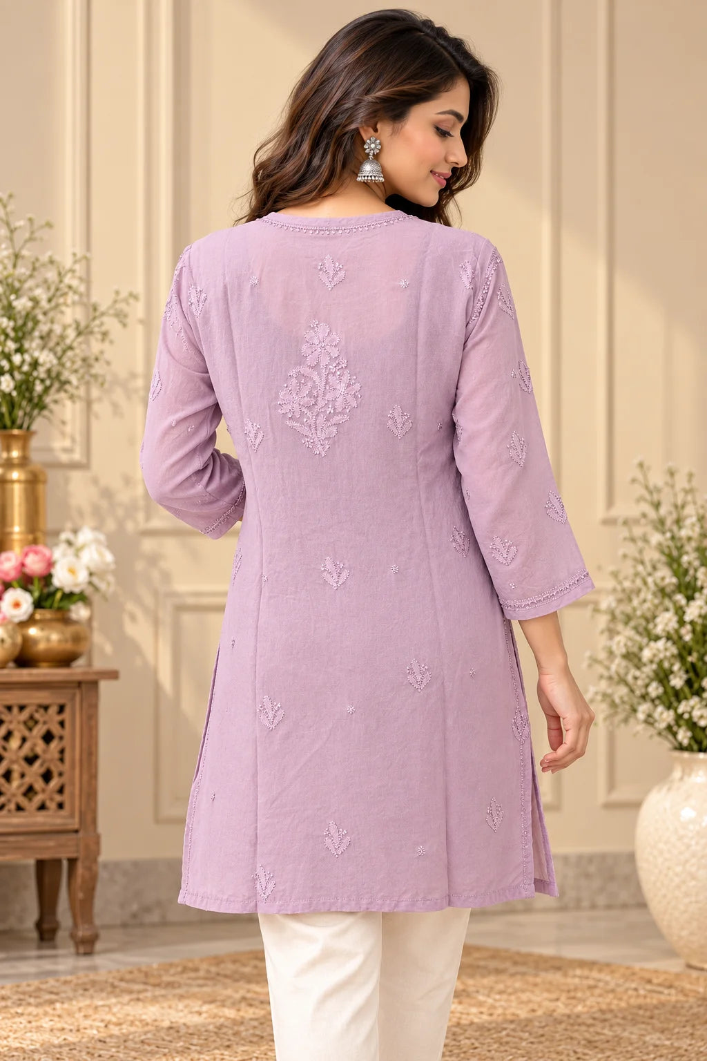Woman wearing a lucknowi chikankari mauve-colored kurta with white floral patterns