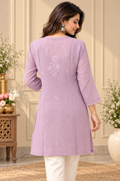 Woman wearing a lucknowi chikankari mauve-colored kurta with white floral patterns