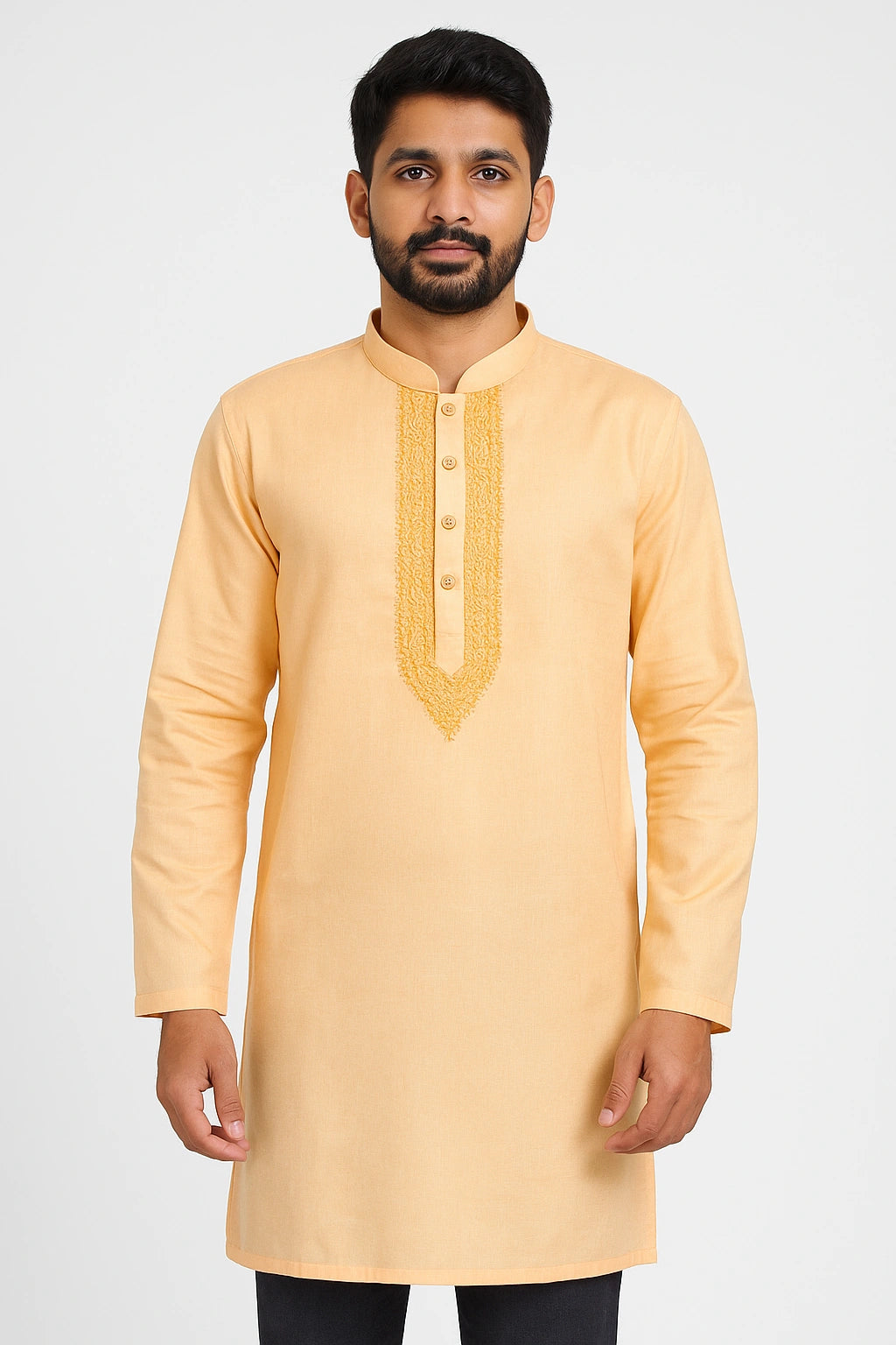 Man wearing a peach kurta with embroidery on a white background