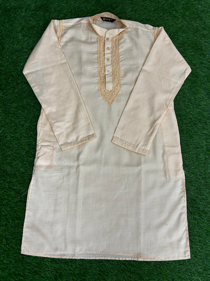 White kurta with gold embroidery on a green background