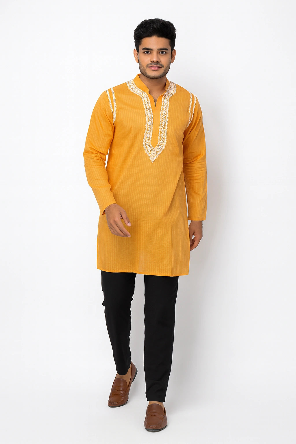 Man wearing a lucknowi chikankari mustard yellow kurta with black pants on a white background