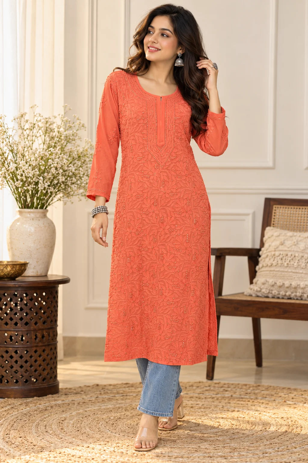 Woman wearing a lucknowi chikankari orange-colored kurta with white floral patterns 